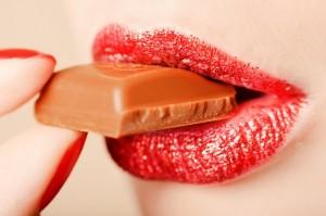 Red lips eating chocolate close-up shot